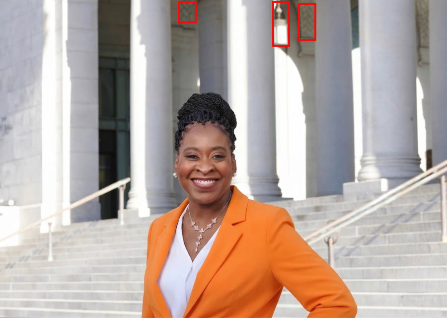 Renita Duncan's campaign photo with red boxes marking a dark paneled doorway, a hanging lantern and patterned tile behind her.